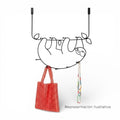 Art by Amapola black metal sloth wall hook, 40cm x 60cm, holding a red beaded bag and necklaces.